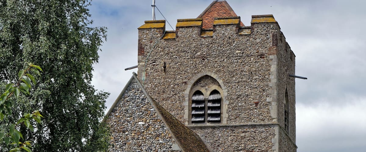 The north-east of the Grade I listed 11th- to 15th-century Parish Church of St Andrew's, from the churchyard north brick wall, with holyhock Alcea rosea and ivy, in Boreham village, Essex, England. Camera: Canon EOS 6D with Canon EF 24-105mm F4L IS USM lens. Software: RAW file lens-corrected, optimized and converted with DxO OpticsPro 11 Elite, and further optimized with Adobe Photoshop CS2.