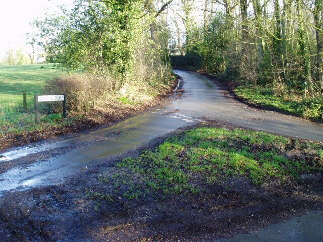A narrow rural road with a sign reading "HAYWOOD CHASE."