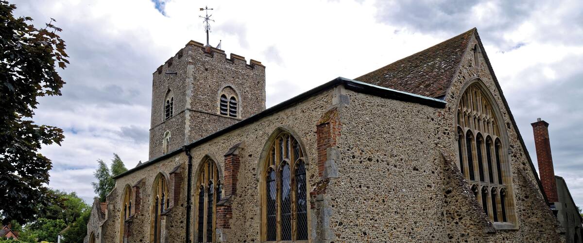 A historic church with a tall tower and arched windows.