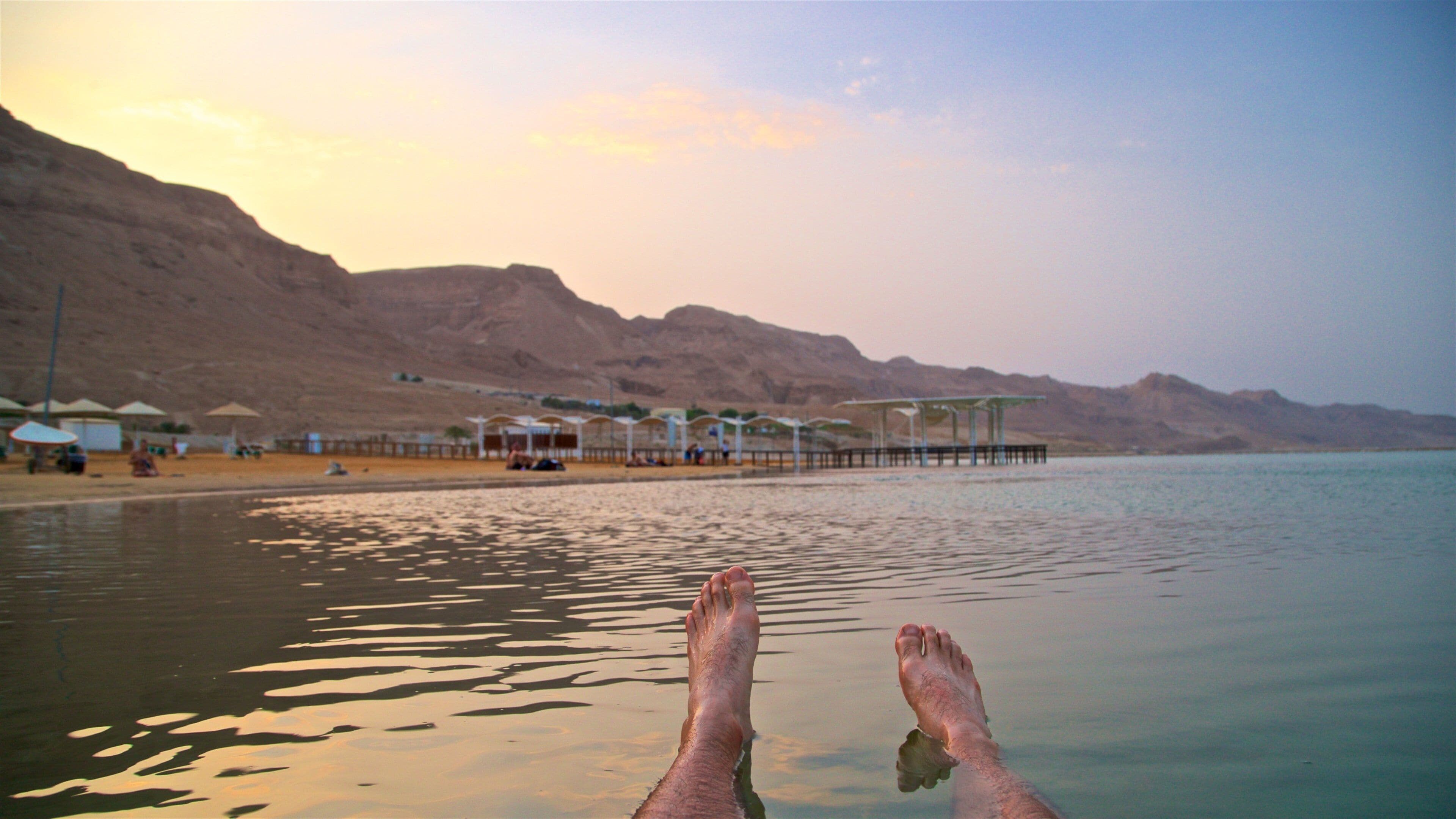 Ein Bokek showing a sunset, a sandy beach and swimming