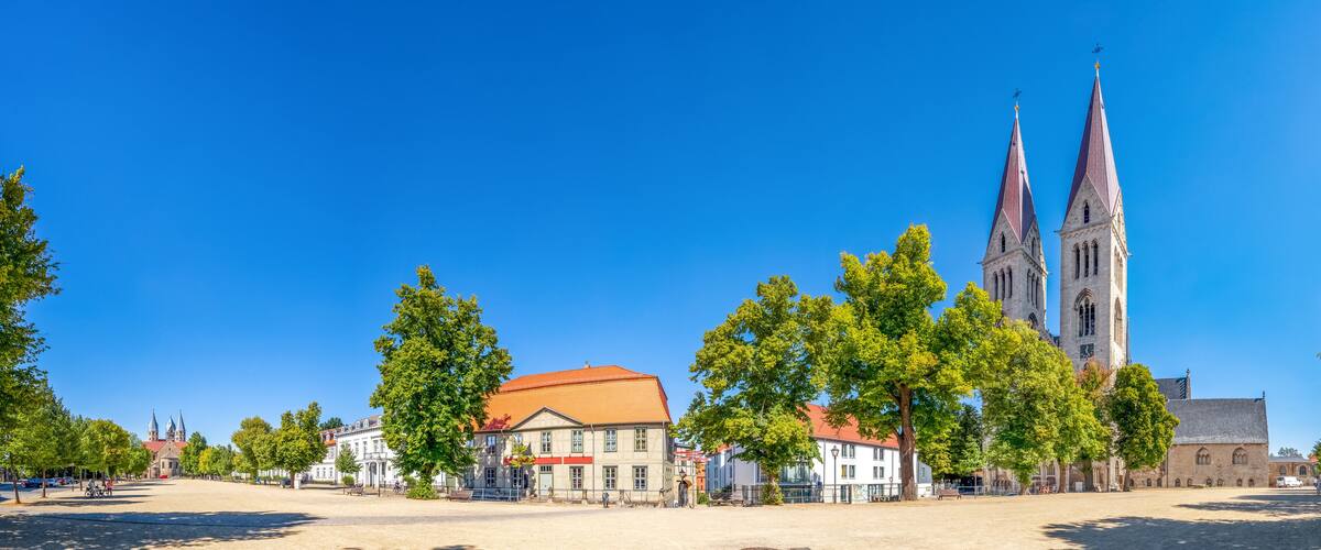 A town square with a church, buildings, and trees.
