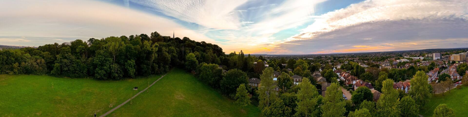 Beautiful summer landscape with green vegetation and a small town. Harrow on the Hill, England, UK.