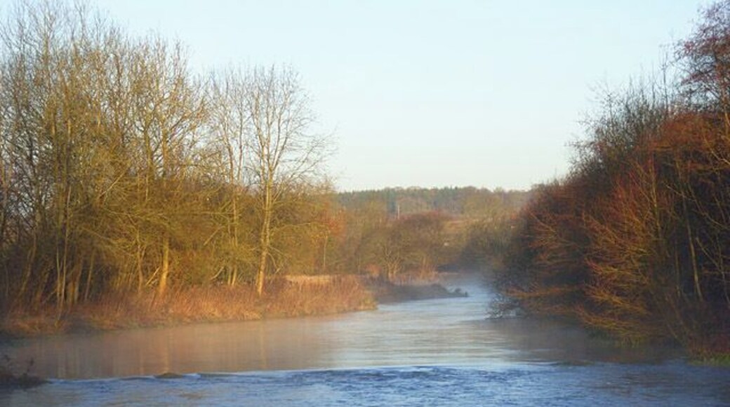 The River Kennet, Chilton Foliat Looking upstream from the footbridge on the footpath to the south of the village. A small weir creates the difference in the appearance of the surface of the water.