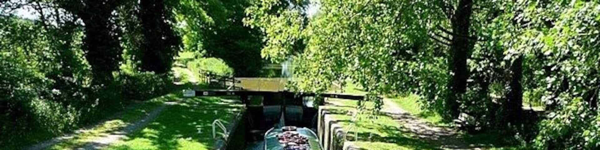 Wire lock Lock 76, with a rise of 6 feet 10 inches. The boat is being used by canal trip boat Rose of Hungerford. She was built especially as a trip boat and is 55 feet long and 10 feet 6 inches wide, thus only filling about three quarters of the 72 feet by 14 feet lock. She takes 50 passengers.