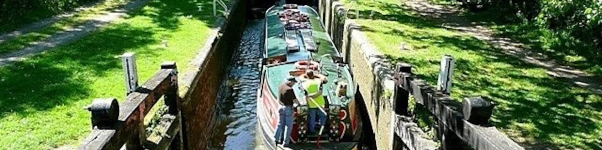 Wire lock Lock 76, with a rise of 6 feet 10 inches. The boat is being used by canal trip boat Rose of Hungerford. She was built especially as a trip boat and is 55 feet long and 10 feet 6 inches wide, thus only filling about three quarters of the 72 feet by 14 feet lock. She takes 50 passengers.