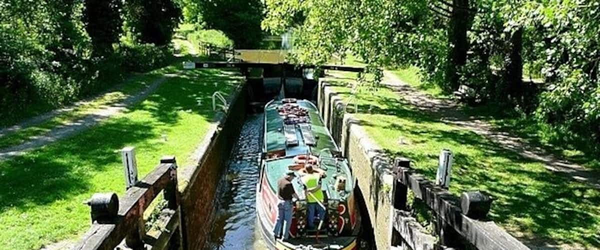 Wire lock Lock 76, with a rise of 6 feet 10 inches. The boat is being used by canal trip boat Rose of Hungerford. She was built especially as a trip boat and is 55 feet long and 10 feet 6 inches wide, thus only filling about three quarters of the 72 feet by 14 feet lock. She takes 50 passengers.