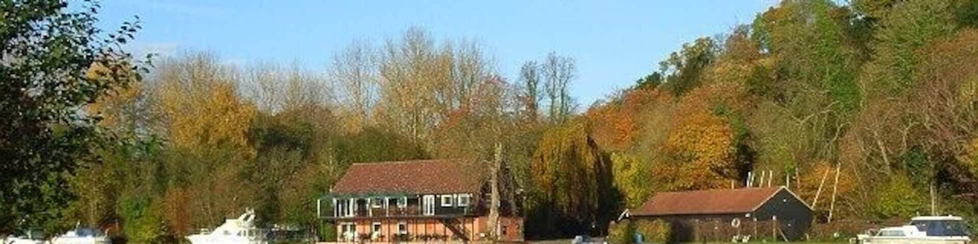 The River Thames, Danesfield Danesfield House is on top of the steep hill rising to the right of picture.