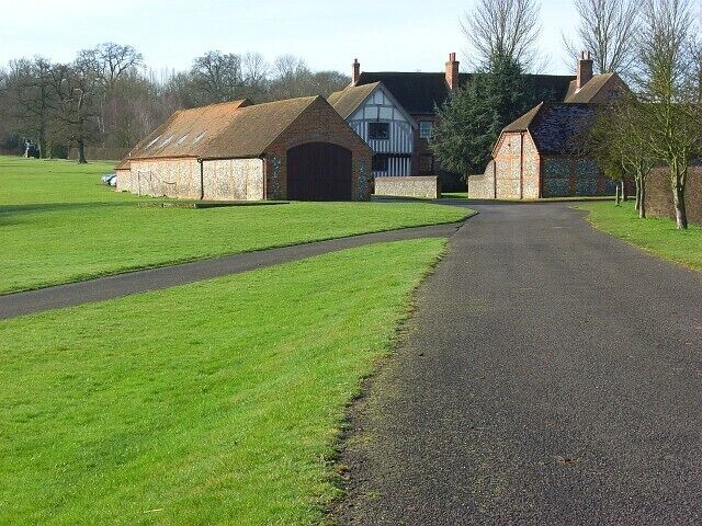 Juddmonte Farm North Approaching on the footpath to the north. An array of brick and flint barns surround the farmhouse, the original part of which dates from the late 15th century.