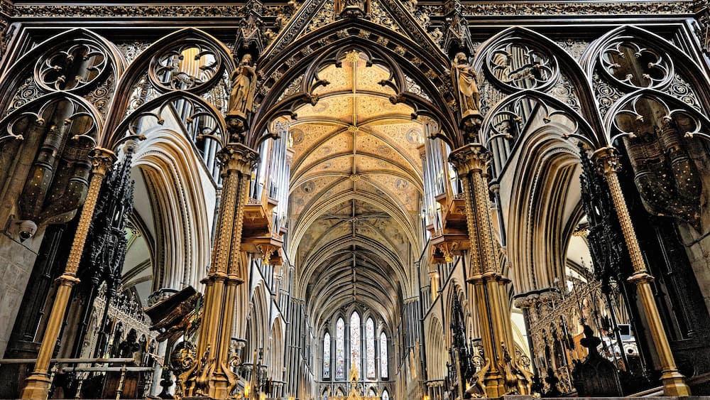 A cathedral interior with Gothic architecture, including pointed arches, ribbed vaults, and ornate columns.