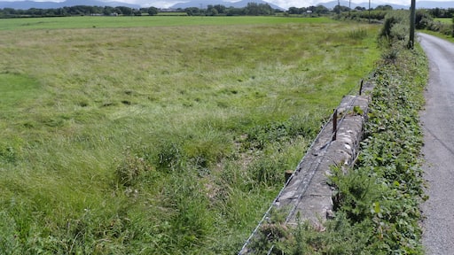 Pont Sarn-Las Hut Group, Brynsiencyn, Anglesey - slight circle earthworks in the uncultivated grassland.