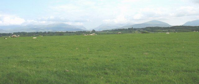 The mountains of North Snowdonia form the background to this sheep grazed pasture land