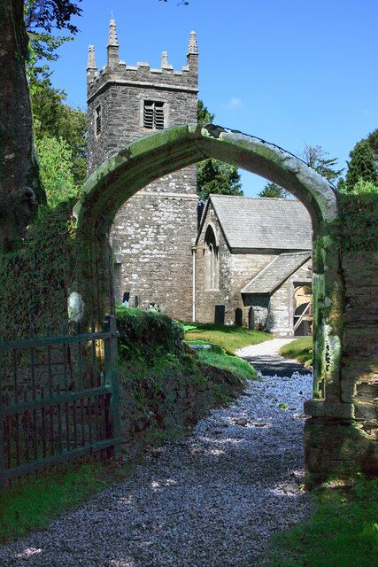 Braddock Church. This unusual stone arched gate is the main entrance to Braddock Churchyard. The church is dedicated to St Mary the Virgin, and dates from Norman times. 1139954 and 1139952.