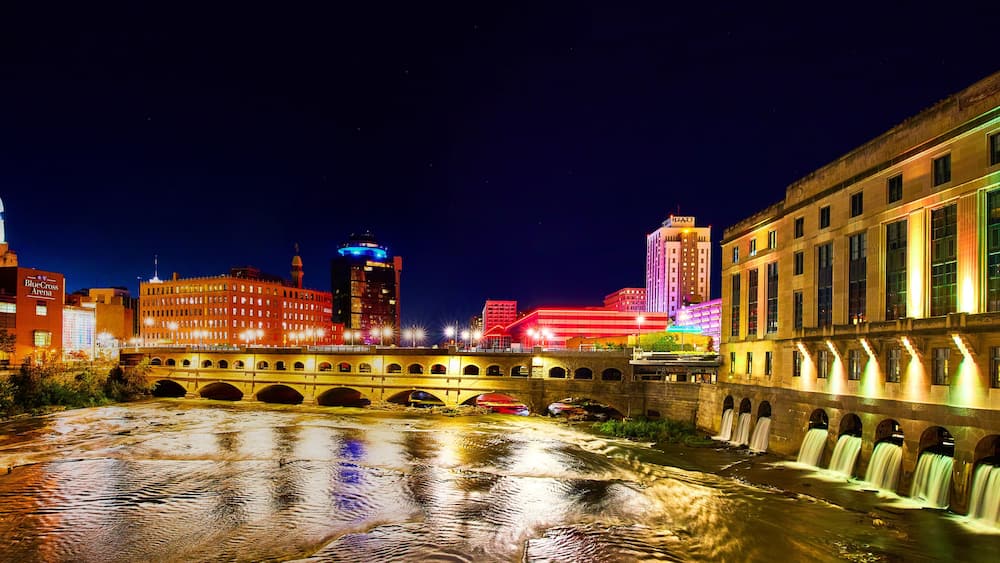 A river with bridges and buildings, including a stadium and a hotel.