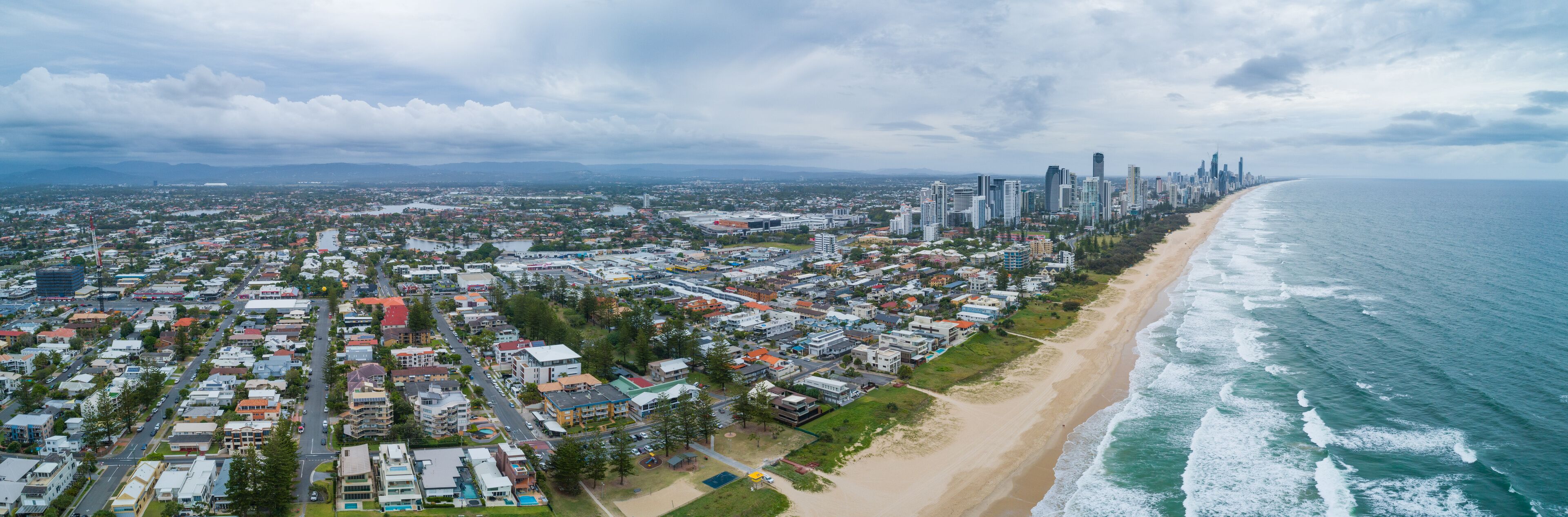 Aerial panorama of Mermaid Beach suburb and Gold Coast city skyline, Queensland, Australia