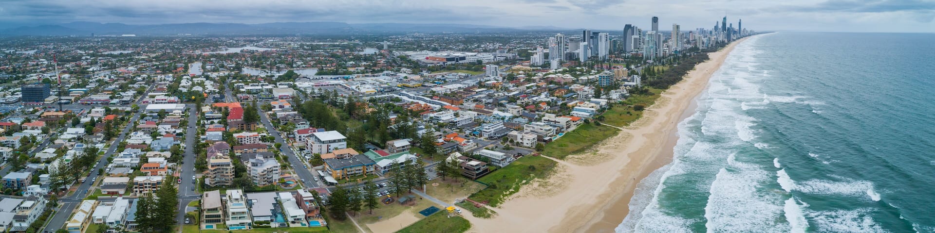 Aerial panorama of Mermaid Beach suburb and Gold Coast city skyline, Queensland, Australia