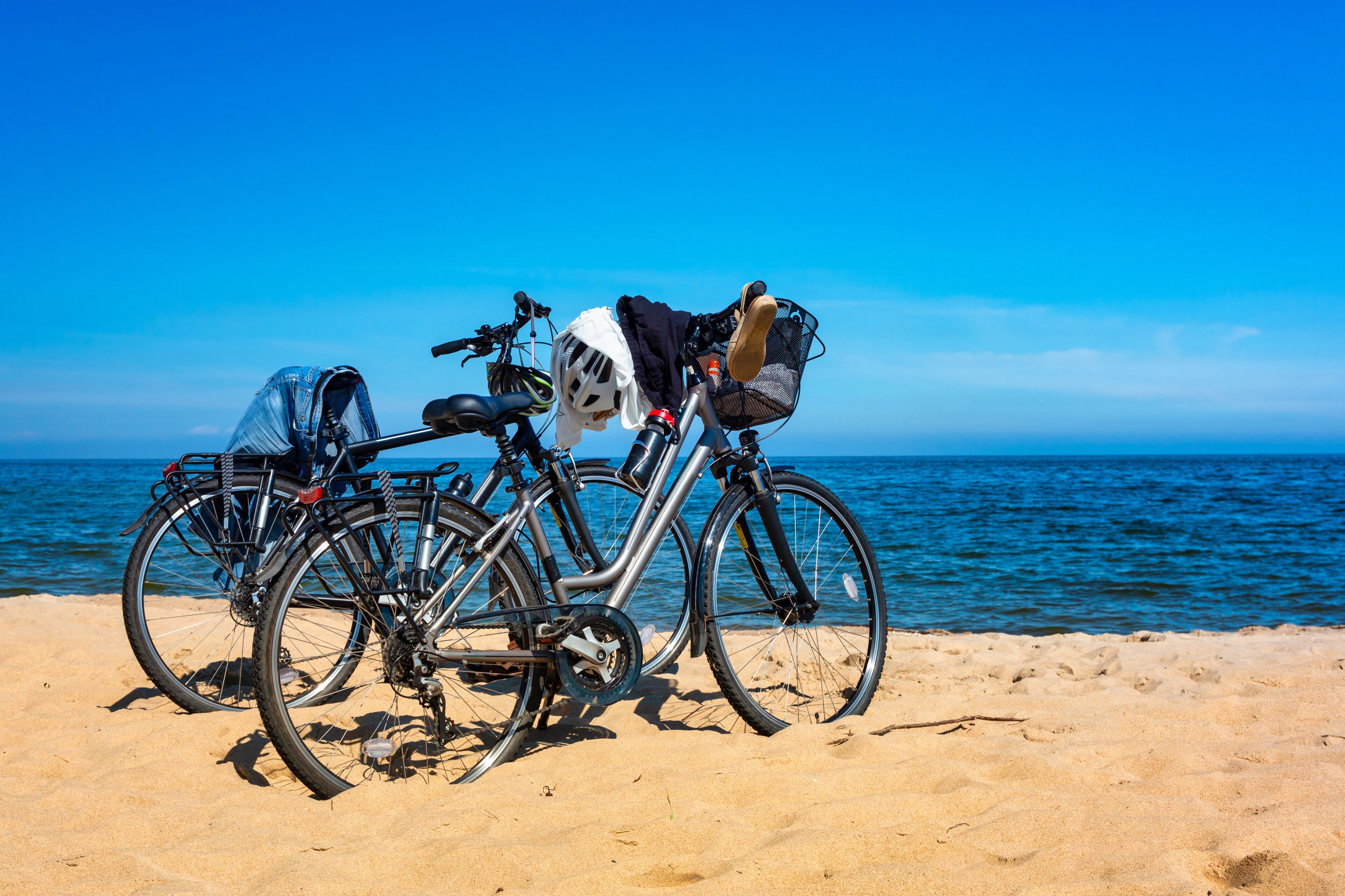 Bicycles on an empty beach of the Baltic Sea in a summer day