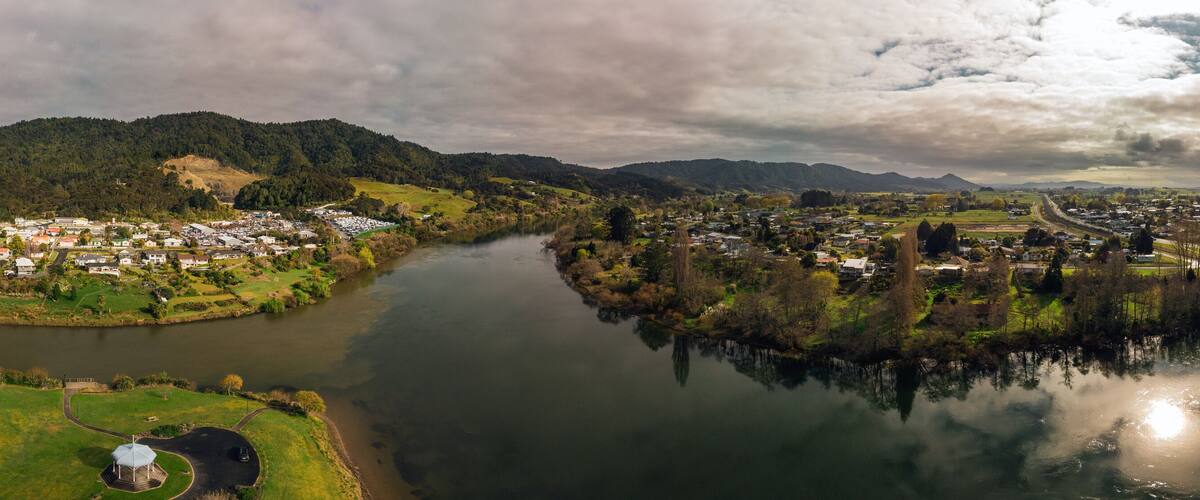 A river winding through a town surrounded by hills.
