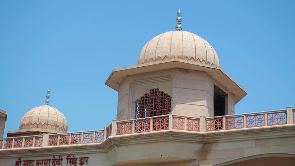 A building with two domed structures and a bridge with a railing.