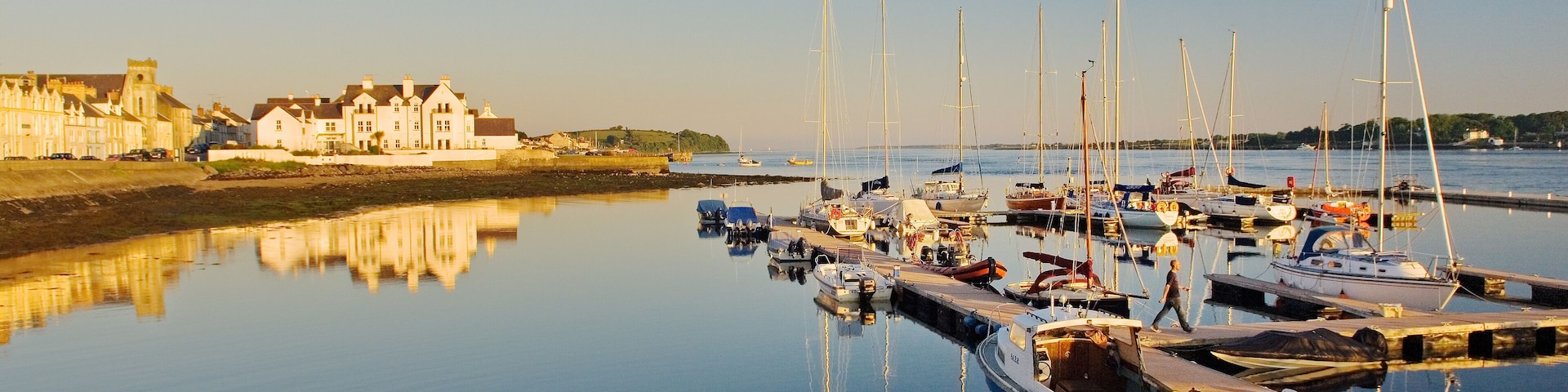Warm summer evening light on the village harbour marina of Portaferry at the entrance to Strangford Lough, County Down, Ireland.