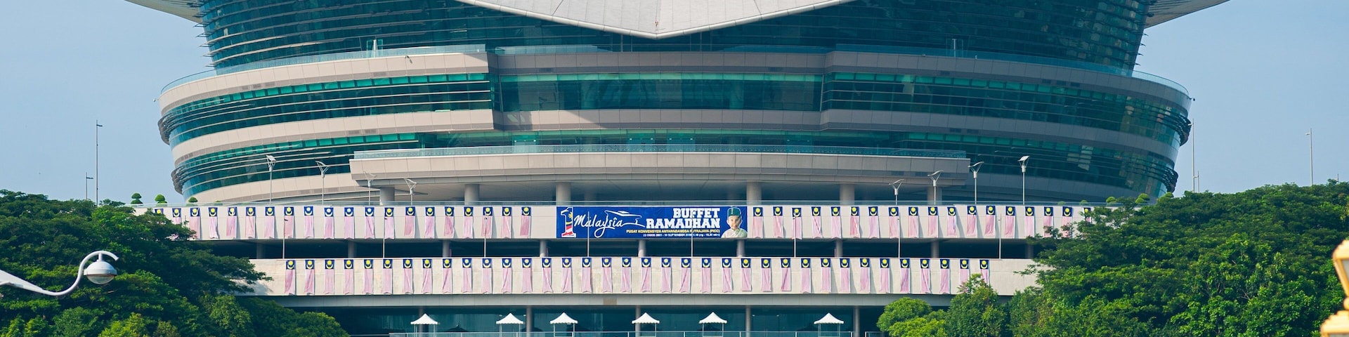 A modern building with a unique, curved design and a large central atrium.