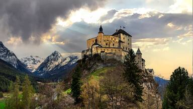 Impressive mountain scenery with amazing medieval castle Tarasp surrounded by Swiss Alps, Canton Grisons or Graubuendon, Switzerland