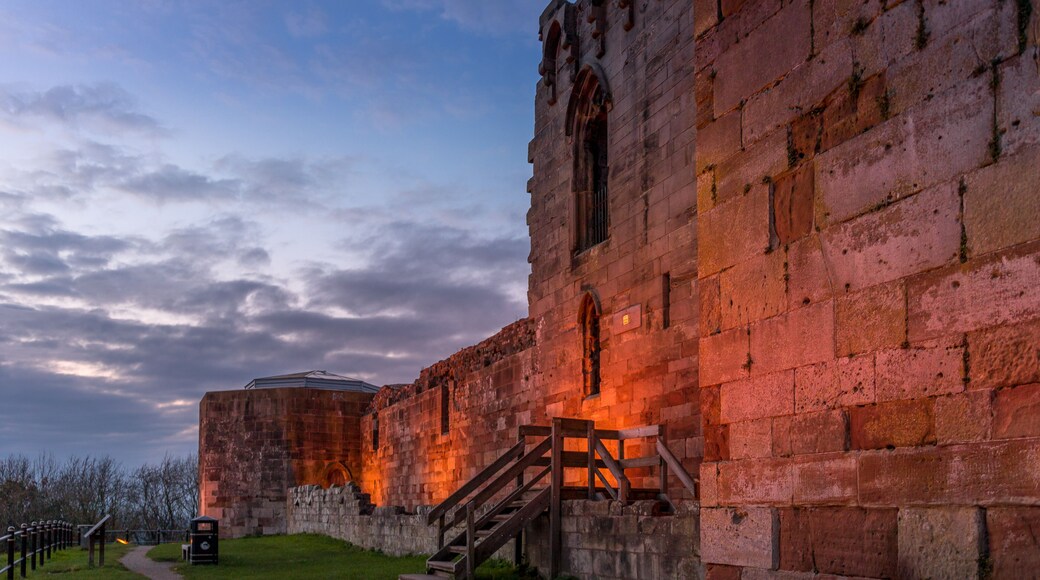 Beautiful sunset on ancient Stafford Castle with colorful sky and light on castle.