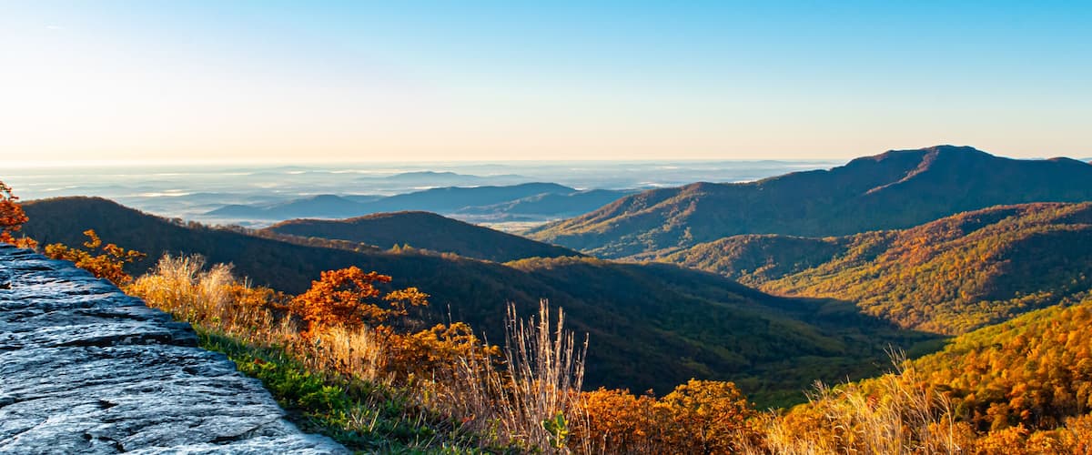 A mountainous landscape with autumn foliage.
