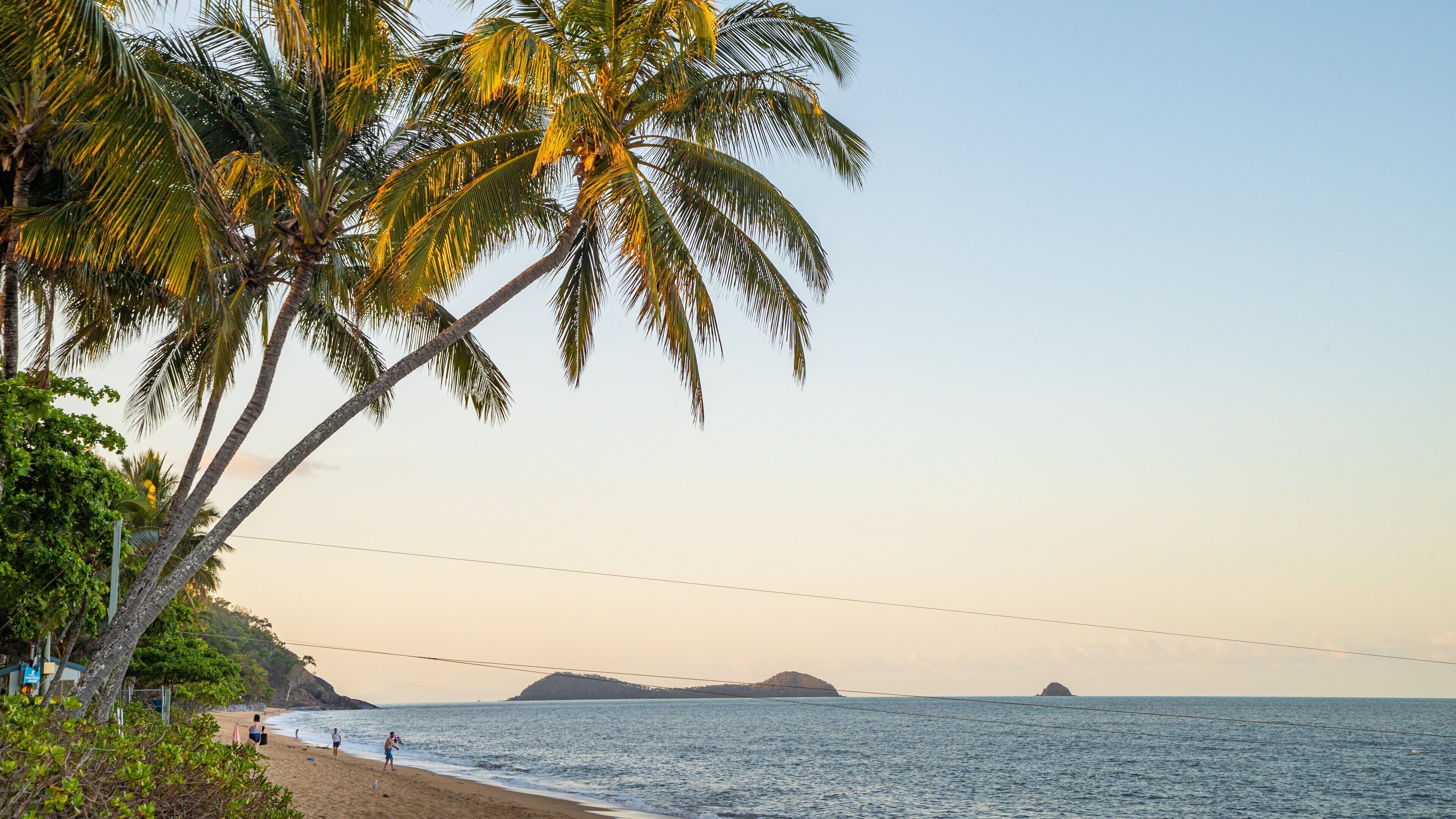 Trinity Beach featuring a sunset, a sandy beach and general coastal views