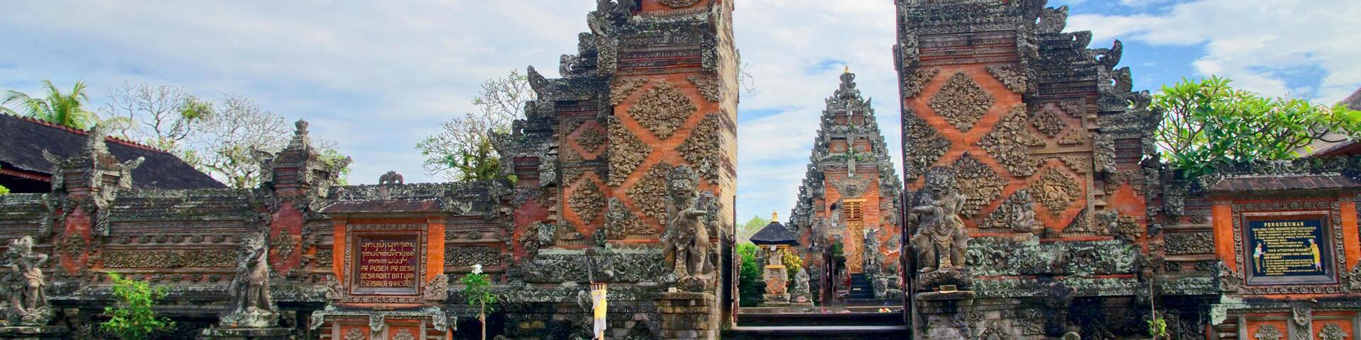 A temple entrance with ornate stone carvings and a staircase leading up to it.