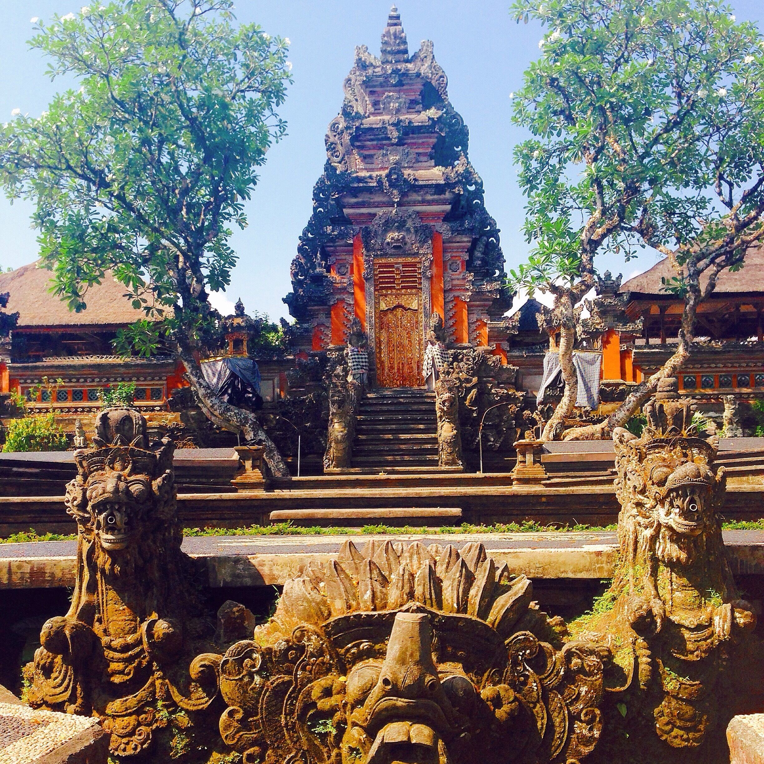 A temple with ornate carvings and a central staircase leading to a roofed entrance.