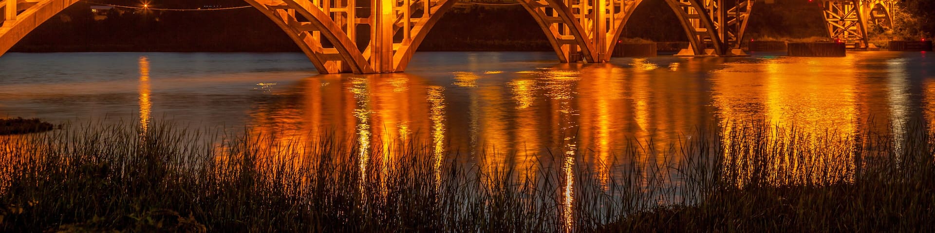 The bridge over the Arkansas River at Ozark Arkansas at dusk with the lights on