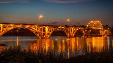 The bridge over the Arkansas River at Ozark Arkansas at dusk with the lights on