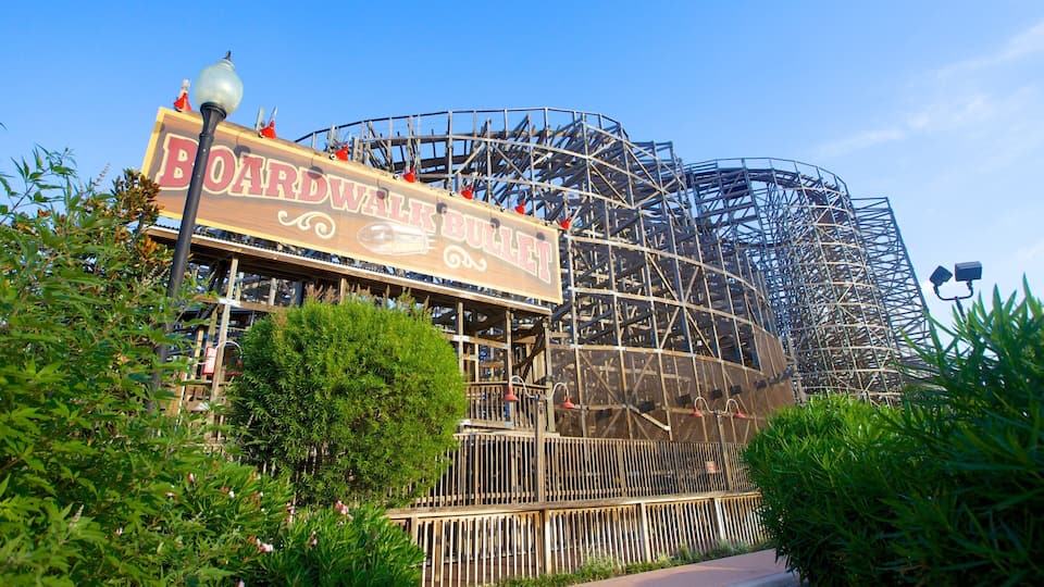 A wooden roller coaster with a sign that reads "Boardwalk Bullet."