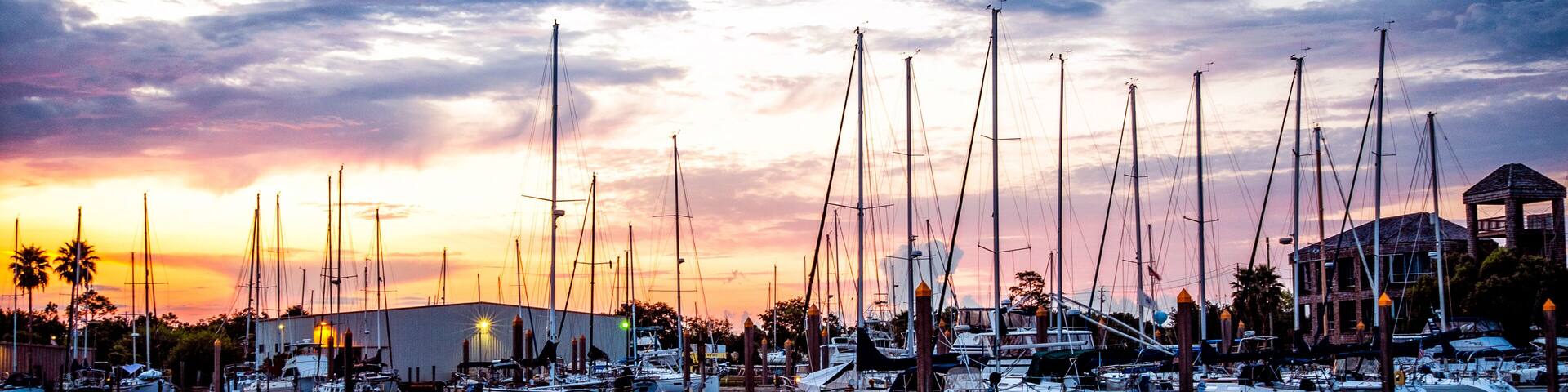 Fresh morning marina sunrise with sailboats and calm water