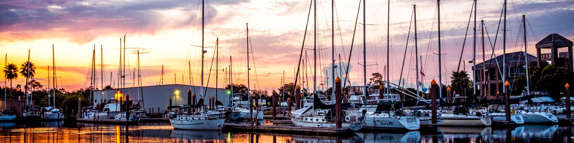 Fresh morning marina sunrise with sailboats and calm water