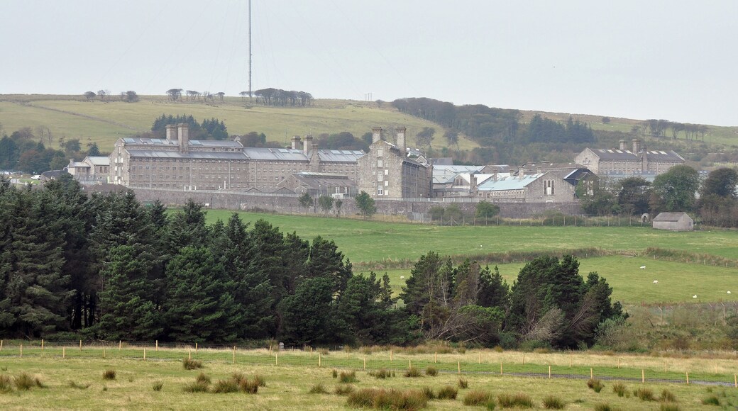 Dartmoor Prison in Princetown with North Hessary Mast and tor visible behind it.