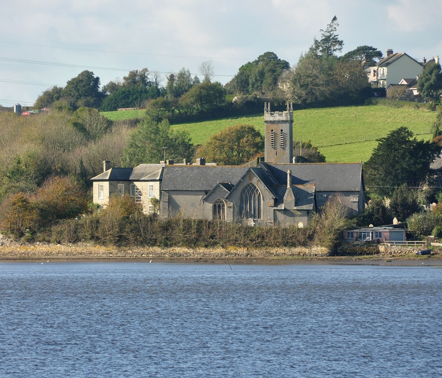 The Church of St Andrew in Bere Ferrers, Devon, seen from Blaxton Quay on the far side of the Tavy Estuary.