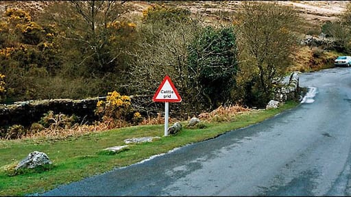 Saddle Bridge, Dartmoor. This scene shows the lane between Venford and Hexworthy, near to the bottom of the hill as it passes over Saddle Bridge. The cattle grid indicates a land boundary is coming up. This is just out of sight, beyond the green car at the bottom of the hill. To the left of the bridge, the foundations for an old stone building are still clearly evident, but I'm not sure what this would have been.