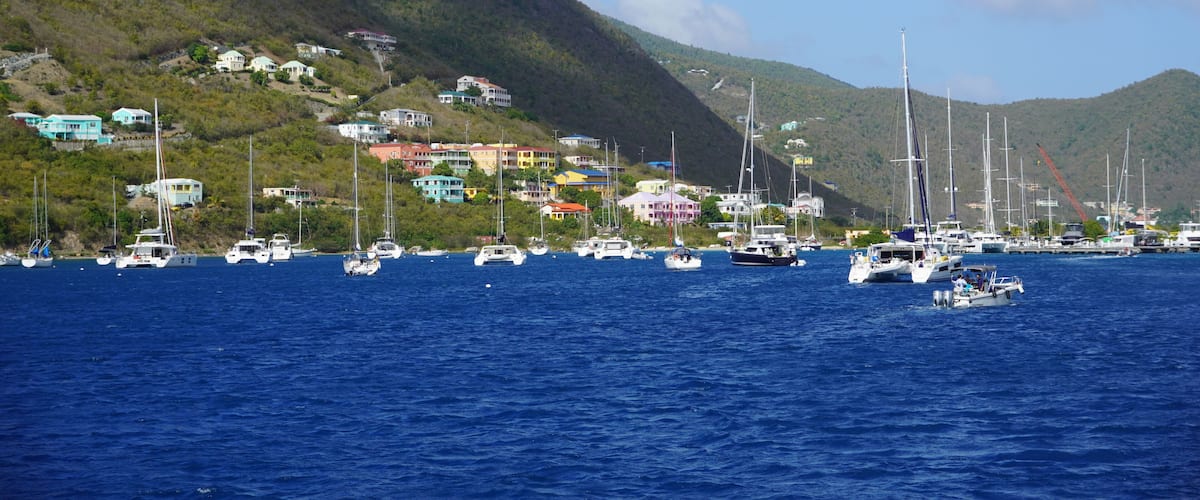 A coastal town with colorful houses and sailboats on the water.