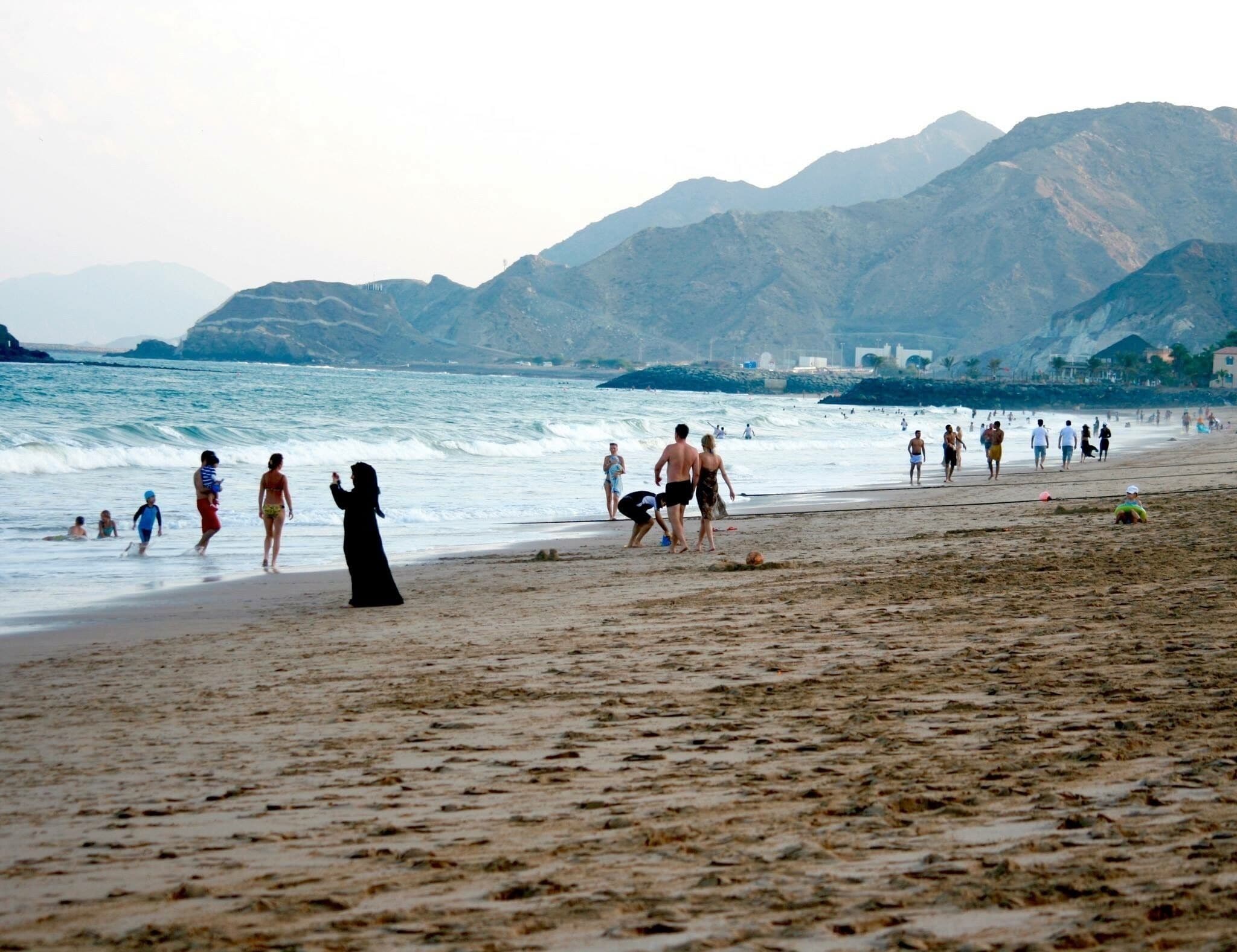 The sun had just got down.  I like this contradiction of local and western beach attire in the same shot.  Perfectly describes the UAE.  