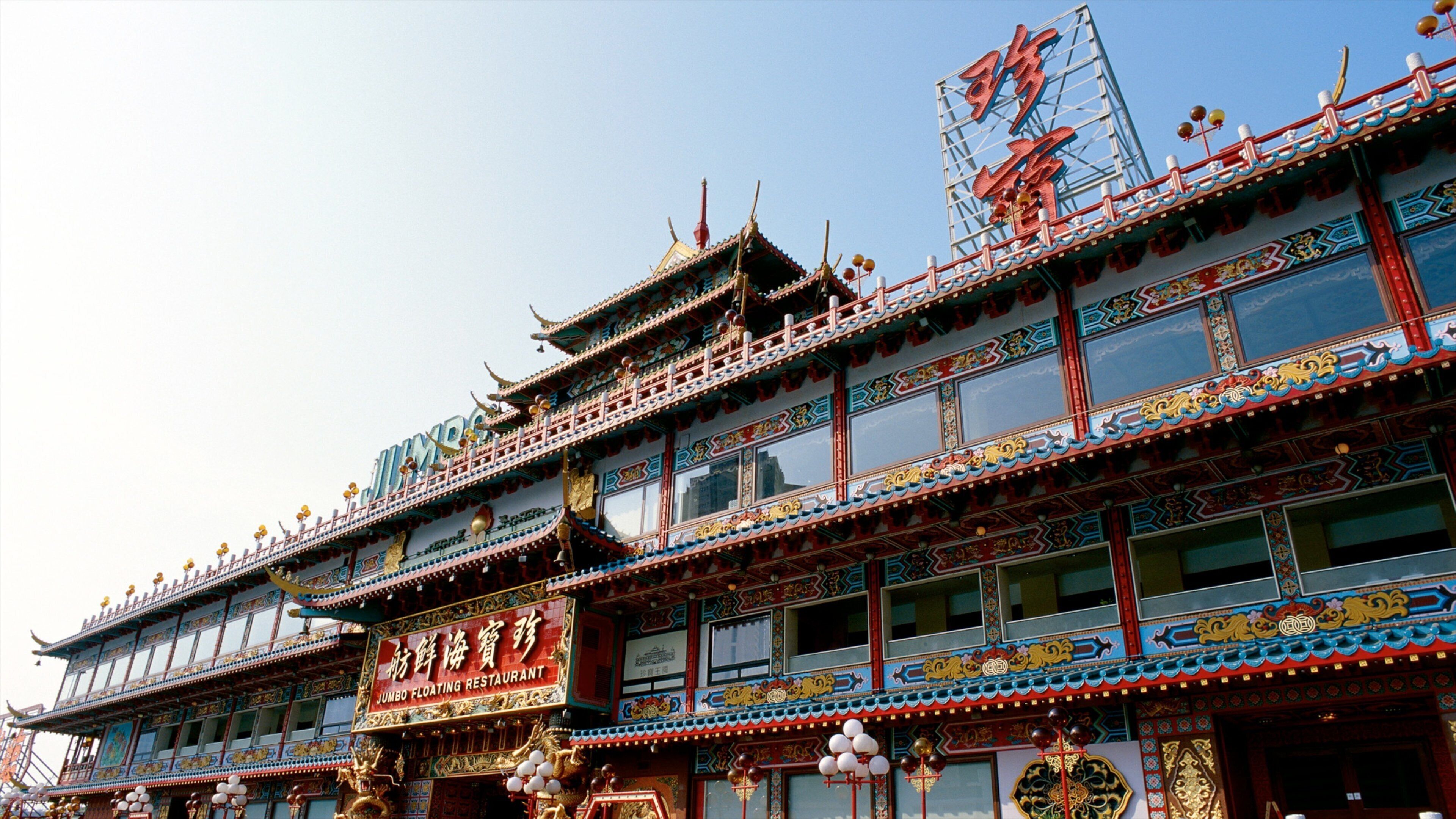 A traditional multi-story building with ornate decorations and signage in a foreign language.