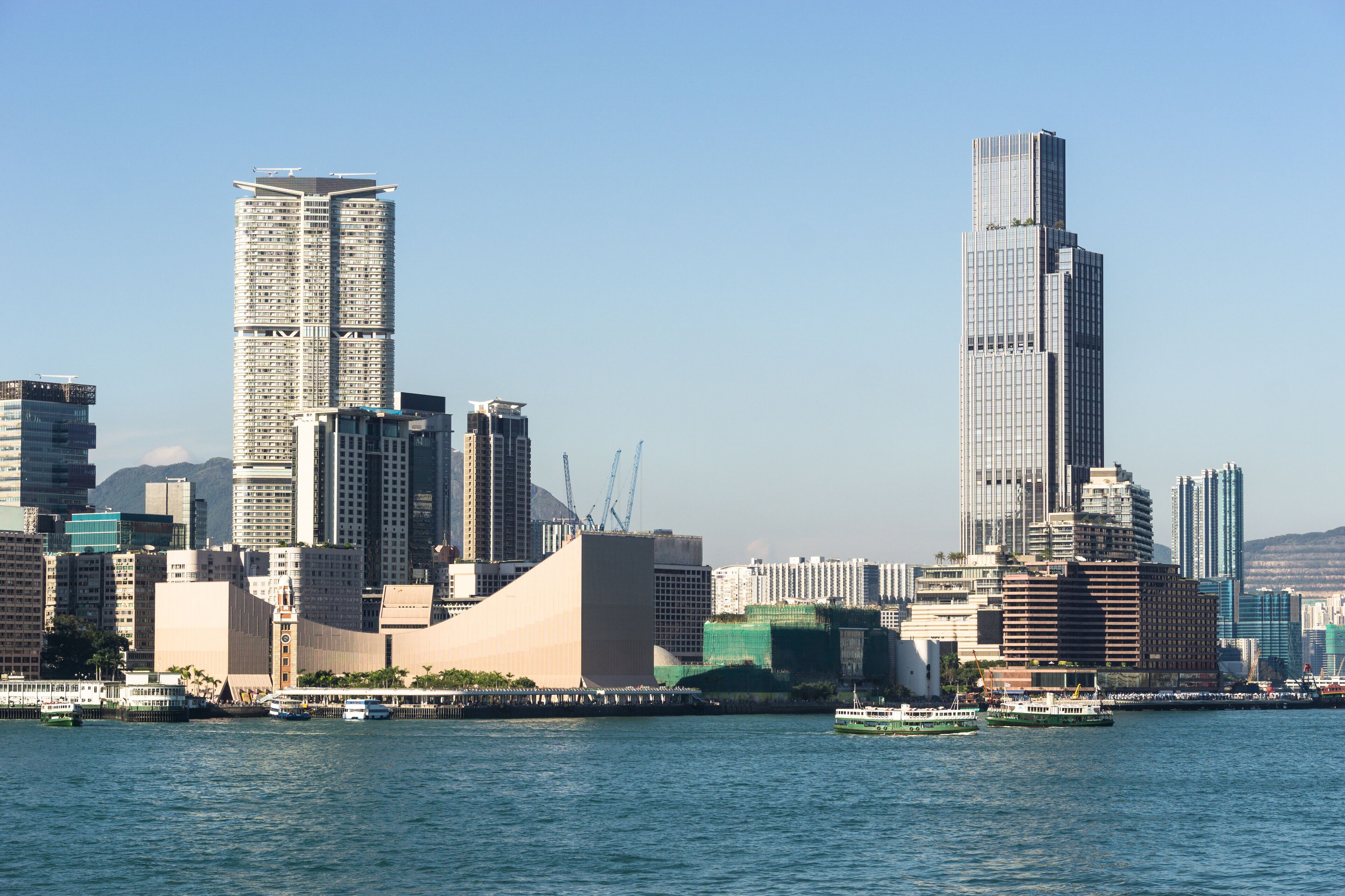 Kowloon skyline at Tsim Sha Tsui view from across the Victoria harbour in Hong Kong on a sunny day in China SAR.