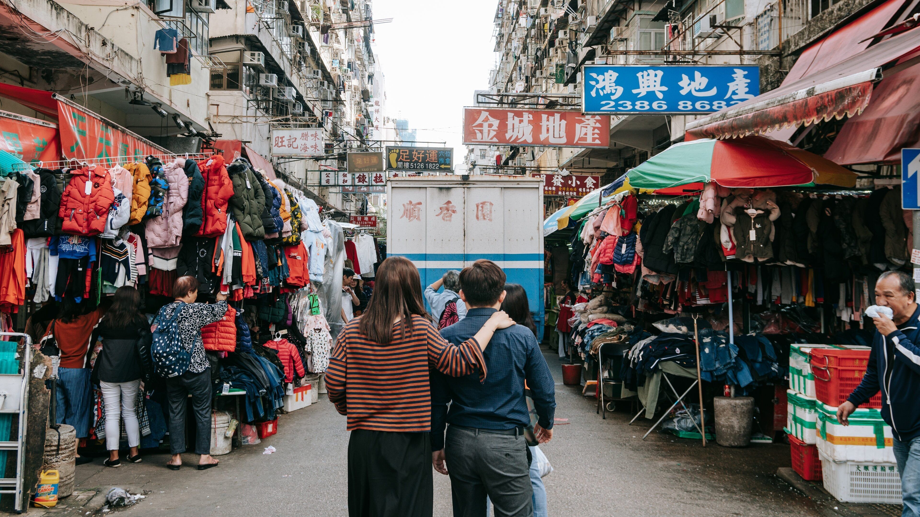 Sham Shui Po showing markets and street scenes as well as a couple
