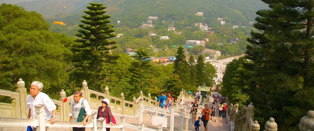 A mountainous landscape with a temple at the top of a staircase.