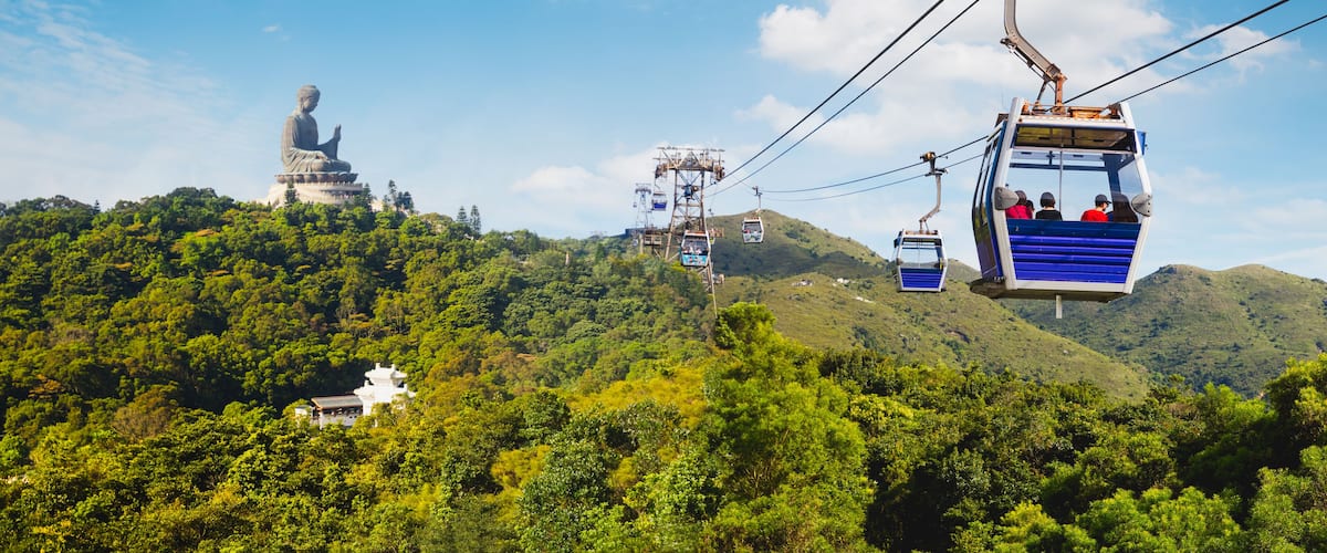 Ngong Ping cable car with big buddha statue in background, Hong Kong China, Shutterstock ID 793844776, Purchase Order: SP-1900, Order Number: SP-1900 Go Guides, Client/Licensee: Hotels.com, Other: Sup