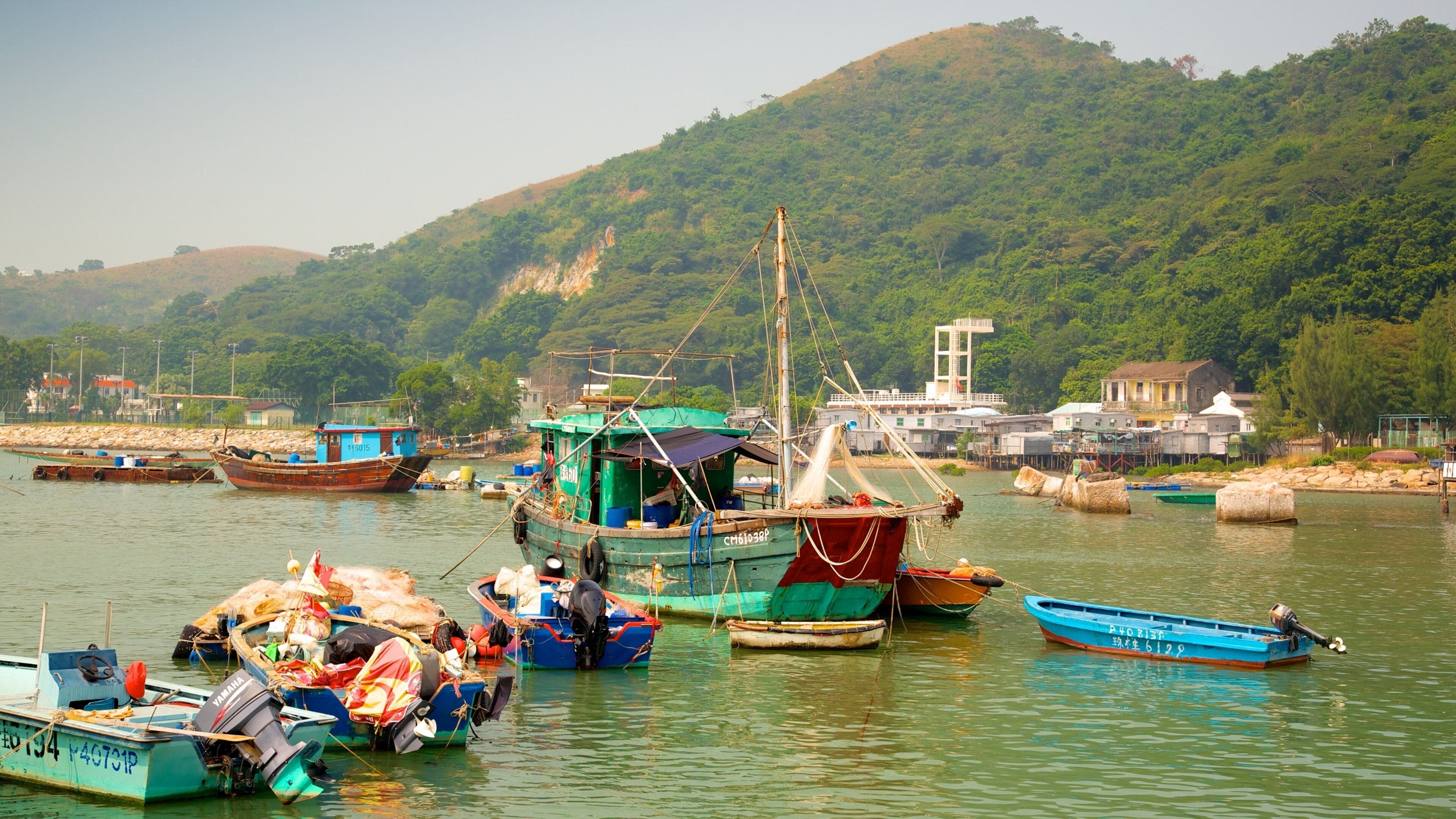 Tai O Fishing Village featuring a bay or harbour, mountains and boating