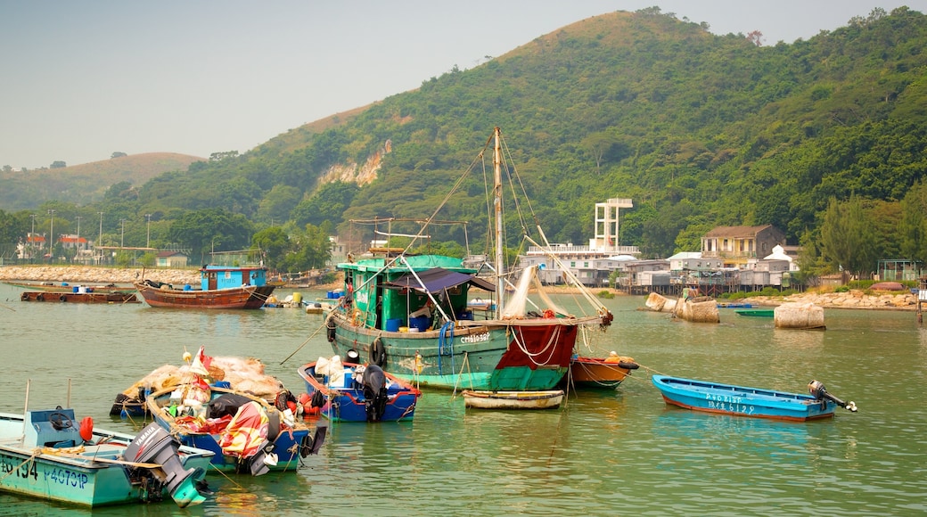 Tai O Fishing Village featuring a bay or harbour, mountains and boating