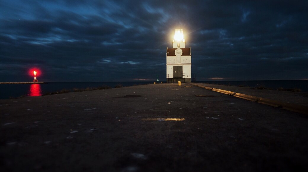 I took this on the pier about a hour after sunset.
The Kewaunee Lighthouse represents the maritime heritage of the harbor while continuing to serve as a navigational beacon to Lake Michigan boating traffic. The property's period of historic significance begins in 1931 when it was established as a lighthouse and ends in 1959, the most recent year of its operation 50 years before the present.
The lighthouse personifies early twentieth century lighthouse architecture and engineering. It exemplifies design and construction methods used in building lighthouses and fog signal buildings on piers during that time period. This structure possesses its original location, setting and design, and embodies historical qualities of integrity in materials, workmanship, feeling and association. The lighthouse lantern room houses a historic fifth order Fresnel lens with an electric light that is currently used by the USCG as a navigational aid. The character and appearance of Kewaunee Pierhead light are largely unchanged from when it was established as an aid to navigation.