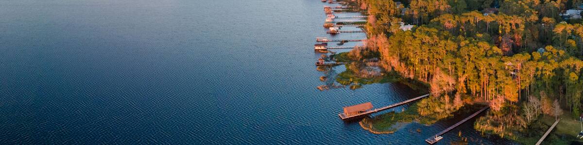 Panoramic aerial photograph of Lake Mary Jane, Orlando Florida. In the distance is the Stanton energy center.