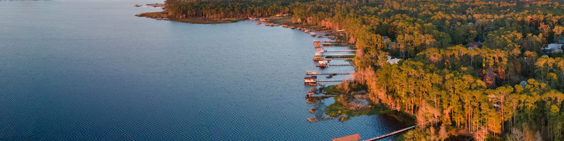 Panoramic aerial photograph of Lake Mary Jane, Orlando Florida. In the distance is the Stanton energy center.